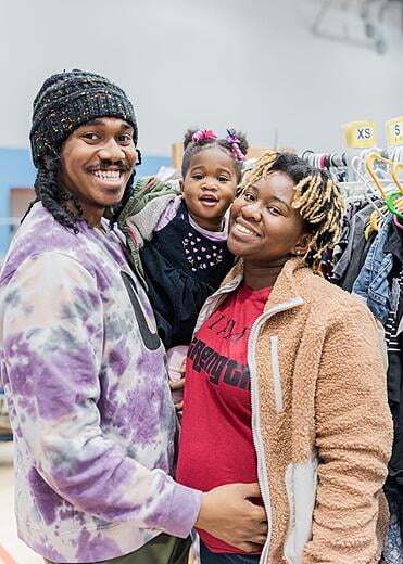 Mother, father and daughter smiling